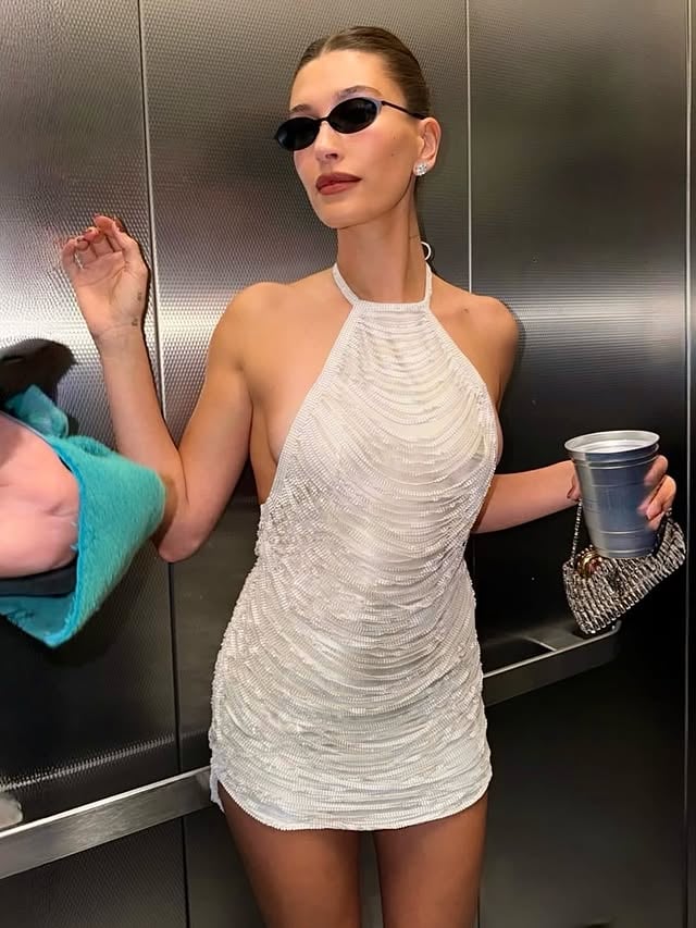 Hailey Bieber debuts Ludovic de Saint Sernin Fall Winter 2026 for the Grammys After Party in Los Angeles, California. She wears a mini backless dress featuring a white metal mesh cascade of fringes draped and embroidered on a soft Japanese fabric base closing at the back with a leather buckled strap. It’s a teaser of what’s to come for LDSS AW26, I can’t wait for you to see what we’re currently working on.@haileybieber is styled by the amazing @andrewmukamal #haileybieber #ludovicdesaintsernin #custom #grammys