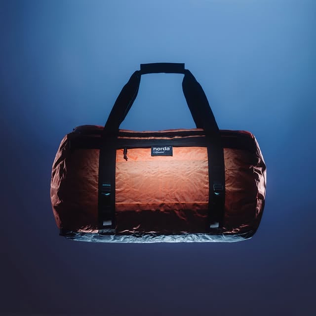 TOOLBOXThe world’s only duffel bag made entirely of bio-circular Dyneema®, the world’s strongest fiber.Designed to contain the full range of our footwear system while still having ample space for other equipment and miscellanea, the Toolbox will support any adventure the mind can conjure. With detachable backpack straps, the bag easily transitions between duffel bag and backpack depending on what your journey requires. The interior features a robust combination of both elasticized and zippered mesh compartments as well as an additional Bio-Dyneema® stow bag for added organizational potential.Available now in Orange, Cinder, White and Stealth Black. Shop via link in bio. by @nordarun