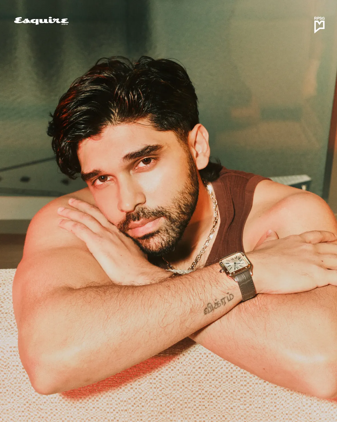 On the right wrist of Dhruv Vikram (@dhruv.vikram) is a tattoo of his father’s name, a permanent reminder of the inheritance he carries. Far from trying to step out of the shadow of Chiyaan Vikram, he sees it as something to embrace, not escape. “We’re intertwined,” he says. 

Chairperson: Avarna Jain (@avarna_jain) 
CEO: Debashish Ghosh 
Editor: Rahul Gangwani (@rahulgangs_) 

Creative Direction & Styling: Vijendra Bhardwaj (@vijendra.bhardwaj) 
Photography: Shawn Paul Tan (@shawnpaultan) 
Contributing Stylist: Mehak Khanna (@mehekkhanna.in) 
Cover story: Sonal Nerurkar (@sonal.nerurkar) 
Hair and grooming: Manisa Tan (@manisatan) 
Bookings Editor: Varun Shah (@varunshah) 
Hospitality Partner: Marina Bay Sands (@marinabaysands) 
 
On Dhruv

Santos-Dumont watch, Love bracelet, Trinity ring and Juste un Clou necklace, diamonds, all by Cartier (@cartier) 

Vest by Cos (@cosstores)

Robe (custom-made) by Shutiq (@shutiqofficial)

An @rpsg.lifestylemedia publication by @rpsggroup. 

#EsquireIndia #DhruvVikram