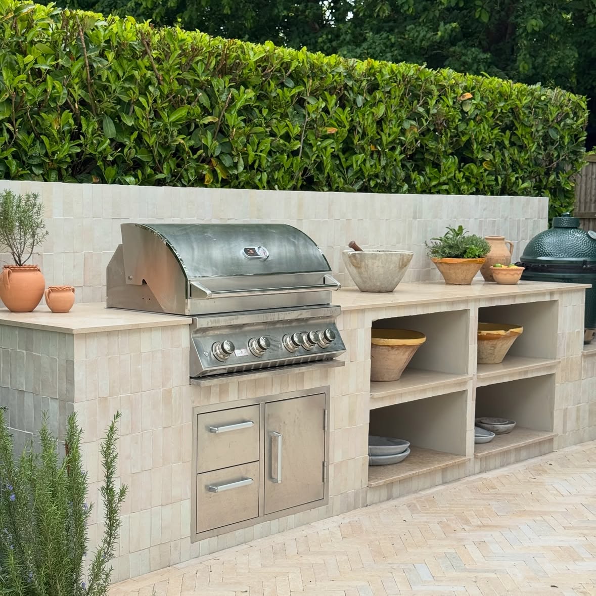 Some stills of my outdoor kitchen showing the stages of the build and design as reference. Any additional questions about this garden project please ask away.

Suppliers and sourcing details as below:
Tiles : Zellige Medina Cloudy White @firedearthuk 

Pavers: Dune Pearl limestone @corkeruk 

Worktop: Jura Beige honed limestone @neostoneuk 

Landscaping: @cowenlandscapes 

Bbq: @whistlergrillsltd_ 

Green egg @biggreenegguk 

#outdoorkitchen #outdoorkitchendesign