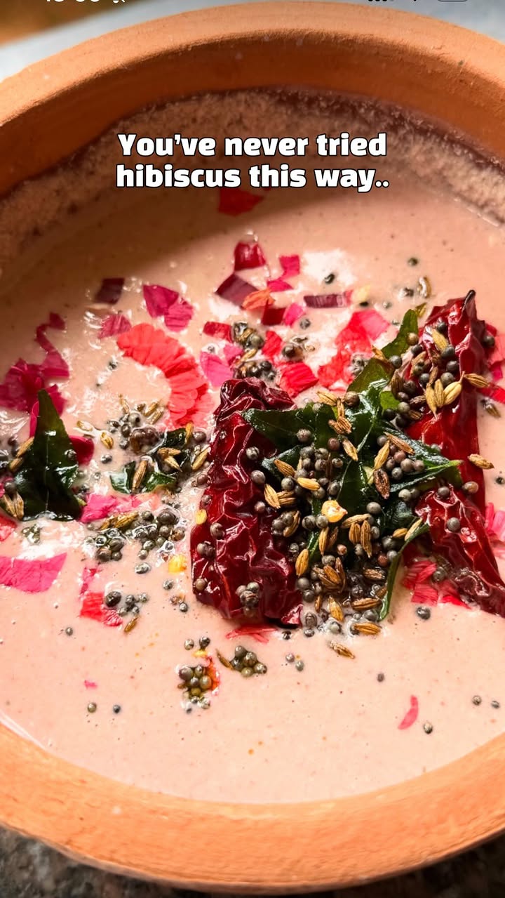 Have you ever tried this? 

Hibiscus Tambuli: This is an extremely cooling and hydrating simple dish made of yogurt and coconut. It’s best enjoyed with rice. Due to its cooling properties, it’s had more during summer times.

*Red hibiscus flowers work best for this recipe, but other colours will work too.*

You’ll need:

* 7–8 organic red hibiscus flowers, avoid pesticide laden ones. And use petals only (as shown in the video)
* 1 cup fresh coconut
* ½ cup fresh buttermilk (avoid sour buttermilk)
* 1 green chilli
* 1 tsp ghee
* 1 tsp cumin seeds
* 3–4 peppercorns
* 3-4 fenugreek (methi) seeds

For the tempering:

* 1 tsp ghee
* 1 tsp mustard seeds
* 1 tsp cumin seeds
* Curry leaves
* 1 dried red chilli

Method:

Wash, and Remove the petals from the flowers as shown in the video.
You just need a few flowers, not too many.
In a pan, heat 1 tsp ghee. Add the cumin seeds, peppercorns, and 4-5 methi seeds. Don’t add too much methi seeds as it will make it bitter . Sauté on low heat until the cumin begins to crackle.

Add the green chilli and fry for about a minute. Add the hibiscus petals, turn off the heat, and stir until they wilt.

Transfer this mixture to a blender along with the fresh coconut and ½ cup buttermilk. Avoid using sour buttermilk. Blend until smooth.

Pour into a bowl and add more buttermilk as needed to reach the consistency shown in the video. Generally tambuli has a diluted , watery consistency although I like it a bit thicker. Add salt as per taste.

For the tempering, heat ghee in a small pan. Add the mustard seeds, cumin seeds, curry leaves, and dried red chilli. Once the cumin crackles and the mustard seeds pop, pour the tempering over the tambuli. Taste and Adjust seasoning, salt etc. 

serve chilled with hot rice. It should have a subtle floral taste❤️

#hibiscusflowers🌺 #healthyindianrecipes #easyindianrecipes #mangaloreanfood #eatmoreplants🌱